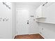 Practical mud room with hooks, white cabinets, and a convenient utility sink area at 2419 Pepperstone Dr, Graham, NC 27253