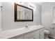 Bathroom with a white vanity, large mirror, and white toilet and hardware at 2474 Sumter Dr, Garner, NC 27529