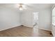 Spacious bedroom with neutral walls, two windows, a ceiling fan and wood-look flooring at 2474 Sumter Dr, Garner, NC 27529
