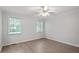Bright bedroom with two windows, ceiling fan and modern, wood-look flooring at 2474 Sumter Dr, Garner, NC 27529