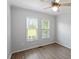 Bright bedroom with two windows and neutral walls and flooring at 2474 Sumter Dr, Garner, NC 27529