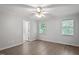 Spacious bedroom with neutral walls, two windows, and a ceiling fan and light fixture at 2474 Sumter Dr, Garner, NC 27529