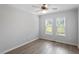 Well lit bedroom with ceiling fan, two large windows and neutral walls and flooring at 2474 Sumter Dr, Garner, NC 27529