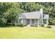 Inviting one-story home with green lawn, a chimney, and manicured landscaping at 2474 Sumter Dr, Garner, NC 27529