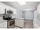 Updated kitchen with stainless steel appliances, white cabinets, and lots of counter space at 2474 Sumter Dr, Garner, NC 27529