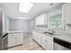 Bright kitchen with white cabinets, views to breakfast area and stainless-steel appliances at 2474 Sumter Dr, Garner, NC 27529