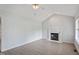 Bright living room with vaulted ceiling, fireplace, and light wood floors at 2474 Sumter Dr, Garner, NC 27529