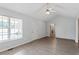 Bright living room with vaulted ceiling, light gray walls and wood-look flooring at 2474 Sumter Dr, Garner, NC 27529