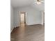 Neutral living room with vaulted ceiling and light wood flooring, adjacent to bathroom at 2474 Sumter Dr, Garner, NC 27529
