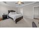 Cozy carpeted bedroom with a trey ceiling and large bed and neutral walls at 31 Sweet Birch Ave, Zebulon, NC 27597