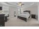 Comfortable carpeted bedroom with large bed, matching furniture and trey ceiling at 31 Sweet Birch Ave, Zebulon, NC 27597