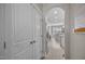 Hallway with view into the kitchen and dining area with white cabinets and appliances at 31 Sweet Birch Ave, Zebulon, NC 27597