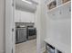 A modern laundry room features stainless steel washer and dryer and lots of storage at 31 Sweet Birch Ave, Zebulon, NC 27597