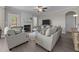 Cozy living room with a fireplace, ceiling fan, neutral decor, and comfortable seating arrangement at 31 Sweet Birch Ave, Zebulon, NC 27597