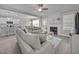 Open-concept living room flows into the kitchen and features a fireplace and neutral color palette at 31 Sweet Birch Ave, Zebulon, NC 27597