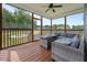 Relaxing screened-in porch features wood floors, a ceiling fan, and plenty of room for seating at 31 Sweet Birch Ave, Zebulon, NC 27597