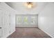 Bright bedroom featuring three large windows and neutral carpeting at 3100 Berkeley Springs Pl, Raleigh, NC 27616