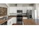 Close-up of the modern kitchen with white cabinetry, stainless steel appliances, and granite countertops at 3100 Berkeley Springs Pl, Raleigh, NC 27616