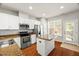 Modern kitchen with stainless steel appliances, granite countertops, and ample cabinet space at 3100 Berkeley Springs Pl, Raleigh, NC 27616