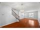 Well-lit living area showcases gleaming hardwood floors, staircase, and a view of the entry at 3100 Berkeley Springs Pl, Raleigh, NC 27616