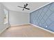 A bedroom with a blue accent wall featuring a grid pattern and a modern ceiling fan at 317 W Murray Ave, Durham, NC 27704