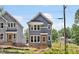 Charming two-story home with gray siding, white trim, and a welcoming front porch at 317 W Murray Ave, Durham, NC 27704