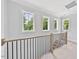 Bright hallway featuring wood trim, an open stairway and large windows at 317 W Murray Ave, Durham, NC 27704