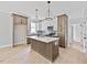 Bright kitchen featuring island, stainless appliances, and modern lighting at 317 W Murray Ave, Durham, NC 27704