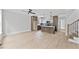 Spacious living room with an open floor plan, light wood floors, and modern kitchen view at 317 W Murray Ave, Durham, NC 27704