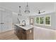 Open concept living and kitchen space with light wood floors and modern finishes at 317 W Murray Ave, Durham, NC 27704
