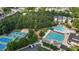 Community aerial view showcasing pool, tennis courts, playground, parking, and lush greenery at 3311 Canoe Brook Pkwy, Raleigh, NC 27614