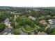 Aerial view of a neighborhood with winding roads, green spaces, and well-maintained homes at 3311 Canoe Brook Pkwy, Raleigh, NC 27614