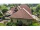A brick house with a large backyard, screened-in porch, and patio furniture surrounded by green foliage at 3311 Canoe Brook Pkwy, Raleigh, NC 27614