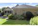An eye-level shot of a backyard features a brick house and manicured green lawn at 3311 Canoe Brook Pkwy, Raleigh, NC 27614