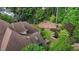 Aerial view of a home with a lush backyard featuring a pond, mature trees, and a patio area at 3311 Canoe Brook Pkwy, Raleigh, NC 27614