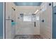 Tiled walk-in shower featuring stone pebble flooring and glass door at 3311 Canoe Brook Pkwy, Raleigh, NC 27614
