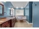 Bathroom featuring granite countertops, a soaking tub, and a privacy window at 3311 Canoe Brook Pkwy, Raleigh, NC 27614