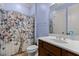 Powder blue bathroom featuring a vanity and a butterfly-themed shower curtain at 3311 Canoe Brook Pkwy, Raleigh, NC 27614