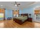 Spacious main bedroom featuring a wooden bed frame and hardwood floors at 3311 Canoe Brook Pkwy, Raleigh, NC 27614