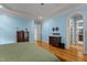 Spacious main bedroom featuring hardwood floors, blue walls, and an ensuite bathroom at 3311 Canoe Brook Pkwy, Raleigh, NC 27614