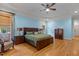 Spacious main bedroom featuring a wooden bed frame, a ceiling fan, and hardwood floors at 3311 Canoe Brook Pkwy, Raleigh, NC 27614