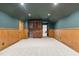 Finished bonus room with wainscoting, a wet bar, and neutral carpet at 3311 Canoe Brook Pkwy, Raleigh, NC 27614
