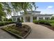 Clubhouse exterior featuring covered front entrance with white pillars and landscaping with turtle statue at 3311 Canoe Brook Pkwy, Raleigh, NC 27614