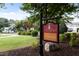 Clubhouse sign next to the community pool, lawn and parking spaces visible at 3311 Canoe Brook Pkwy, Raleigh, NC 27614