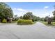 Community entrance featuring brick pillars, landscaping, road, and signage at 3311 Canoe Brook Pkwy, Raleigh, NC 27614
