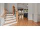 Welcoming entryway showcasing a staircase leading to the upper level and hardwood floors at 3311 Canoe Brook Pkwy, Raleigh, NC 27614