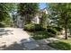 Charming brick home with a basketball hoop, well-manicured lawn, and mature trees at 3311 Canoe Brook Pkwy, Raleigh, NC 27614