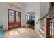 Bright foyer featuring hardwood floors, a staircase, and a view into the dining room at 3311 Canoe Brook Pkwy, Raleigh, NC 27614