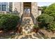 Charming front entrance with stone steps, wrought iron railings, and decorative potted plants at 3311 Canoe Brook Pkwy, Raleigh, NC 27614