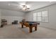 Bright game room with pool table, ceiling fan, and natural light from the large window at 3311 Canoe Brook Pkwy, Raleigh, NC 27614